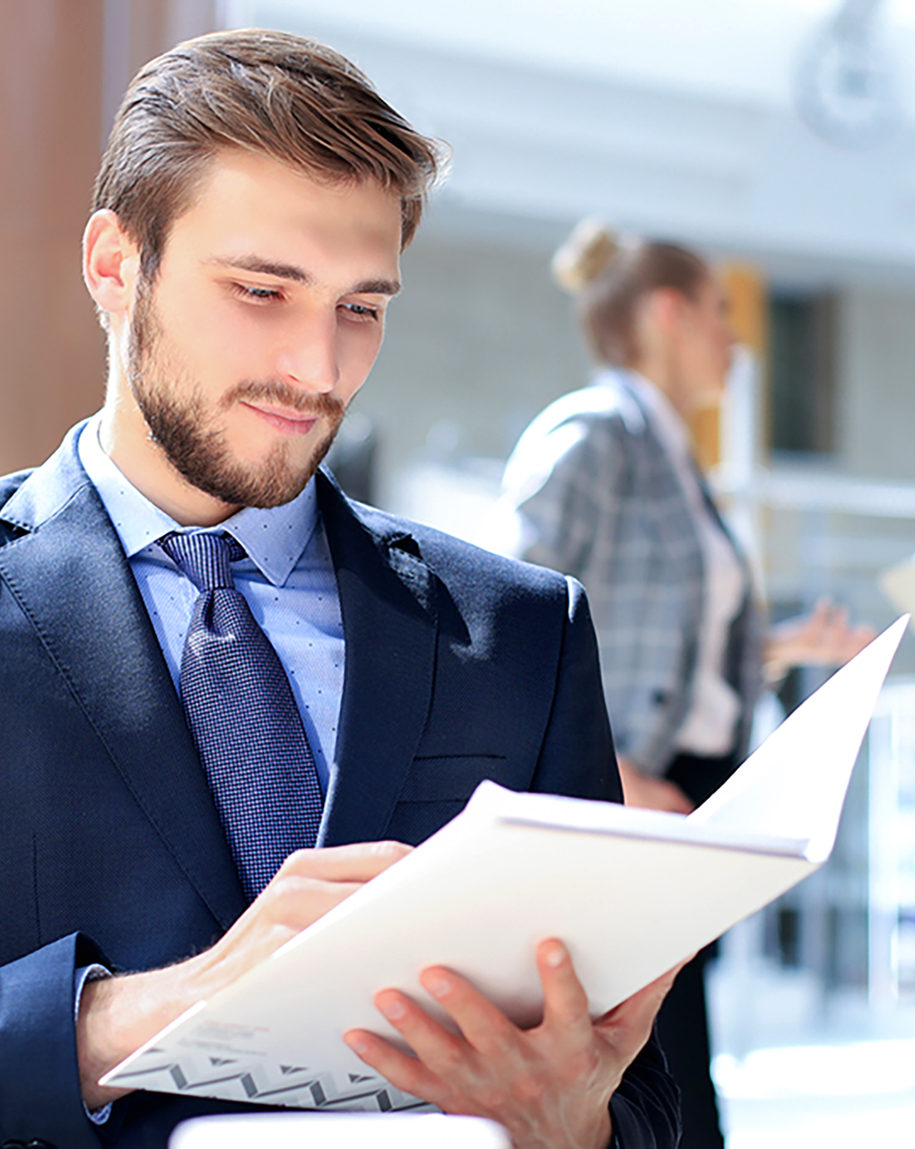 Businessman wearing a suit reading a paper document
